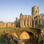 The eastern end of Fountains Abbey, North Yorkshire, a Cistercian community of monks from the twelfth century until the Dissolution in 1539. It is the largest monastic ruin in the country, and a World Heritage Site.