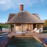 a cottage next to a lake